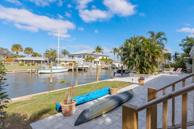 view of dock with a water view and a patio