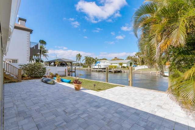 view of patio / terrace with a boat dock and a water view