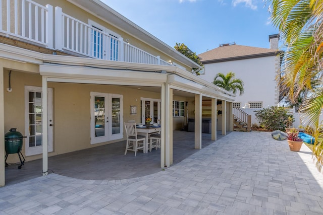 view of patio / terrace with french doors and a balcony