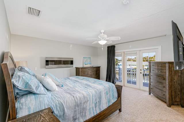 bedroom with access to outside, french doors, light carpet, and ceiling fan