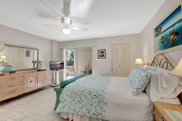 bedroom with ceiling fan, a closet, and a textured ceiling