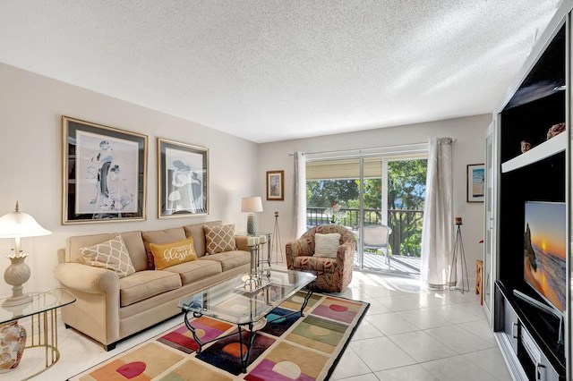 living room featuring light tile patterned flooring and a textured ceiling