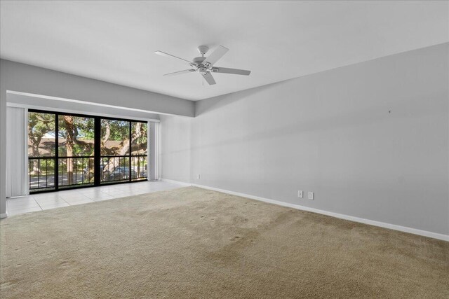 dining space featuring a notable chandelier, light tile patterned flooring, and a tray ceiling