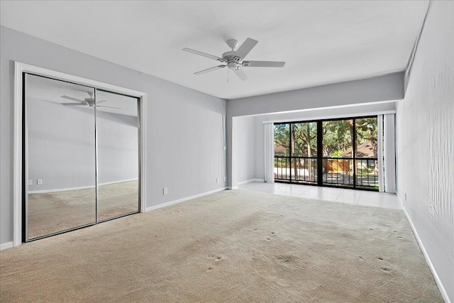 unfurnished room featuring light carpet and ceiling fan