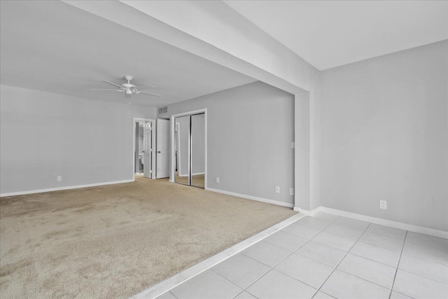 carpeted empty room featuring ceiling fan