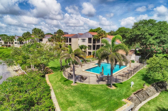 view of pool with a yard