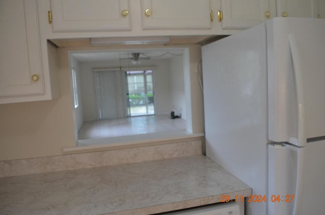 kitchen with white cabinetry, sink, and white appliances