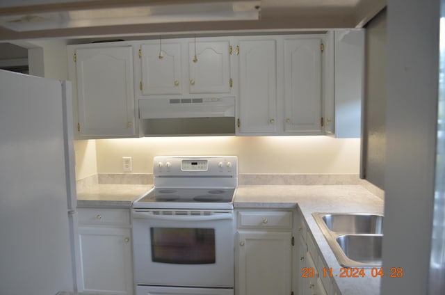 kitchen with sink, white appliances, and white cabinets