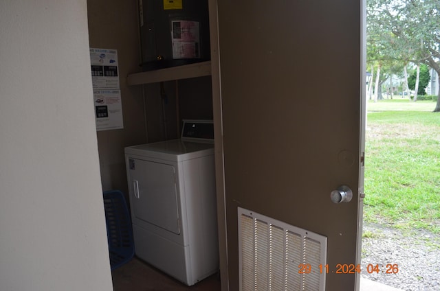 laundry area featuring electric panel and washer / dryer