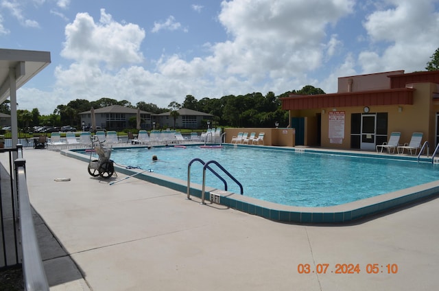 view of swimming pool with a patio