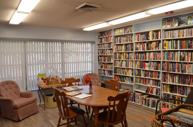 interior space featuring hardwood / wood-style flooring, plenty of natural light, and a textured ceiling