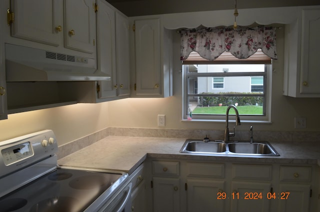 kitchen featuring sink, refrigerator, white cabinetry, and white dishwasher