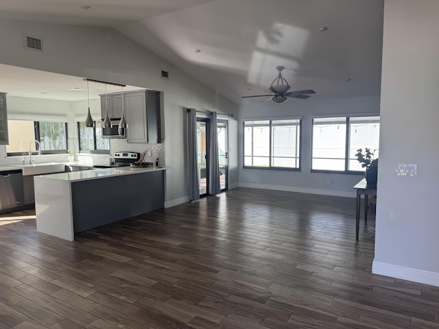 kitchen featuring gray cabinetry, backsplash, hanging light fixtures, ceiling fan, and stainless steel appliances