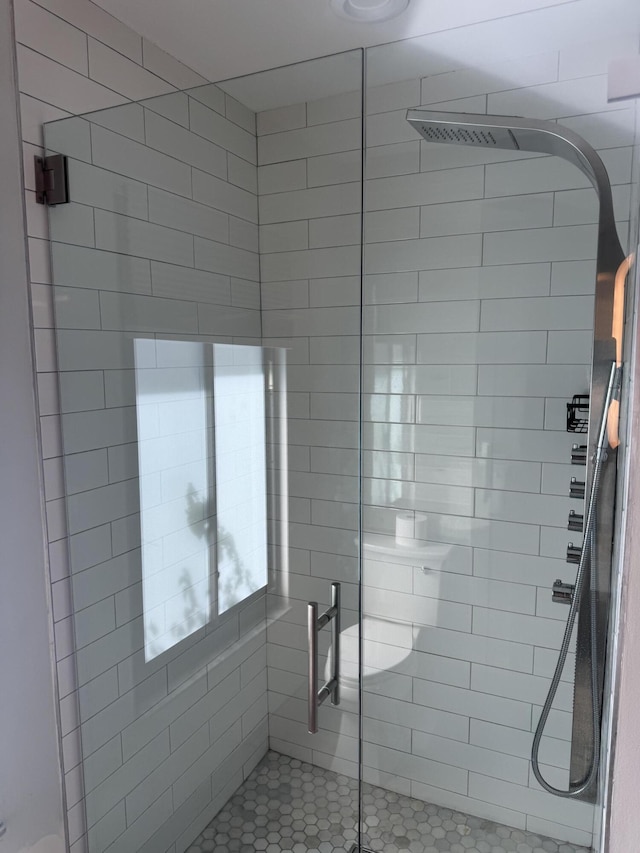 bathroom featuring a shower with door