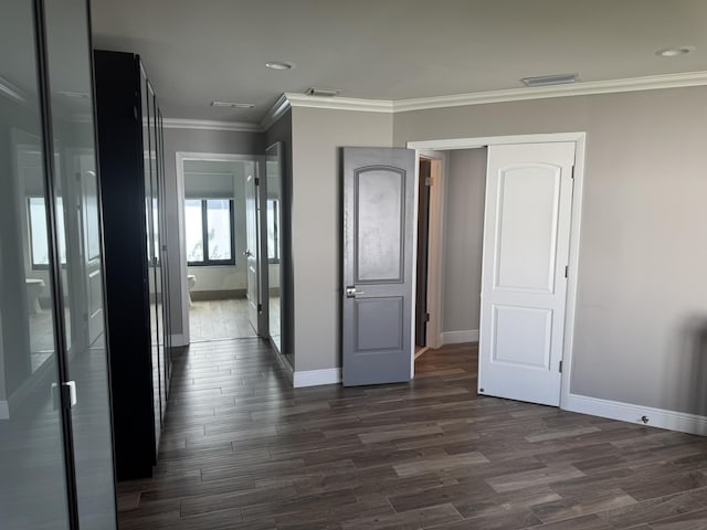 interior space with dark hardwood / wood-style floors and crown molding