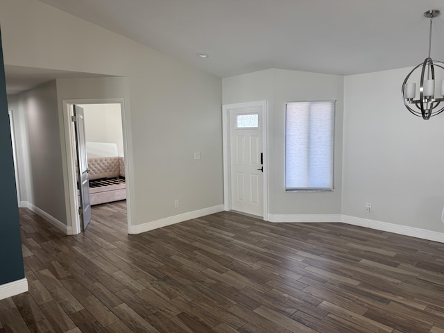 foyer with a chandelier and dark wood-type flooring