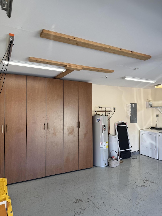 garage featuring electric water heater, electric panel, and washing machine and dryer