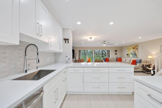 kitchen with white cabinets, backsplash, and sink