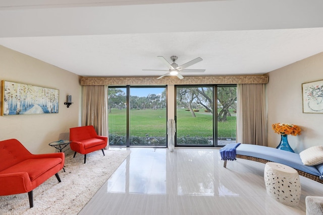 living area with plenty of natural light and ceiling fan