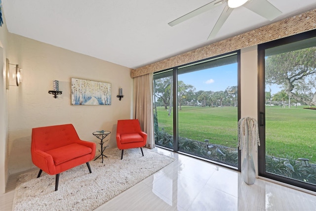 sitting room with tile patterned floors and ceiling fan