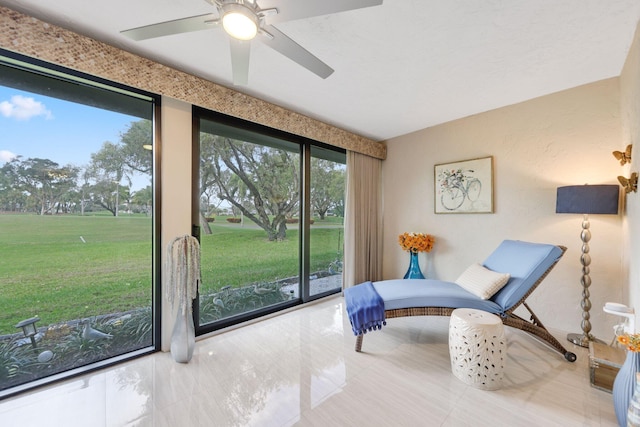 sitting room featuring tile patterned floors and ceiling fan