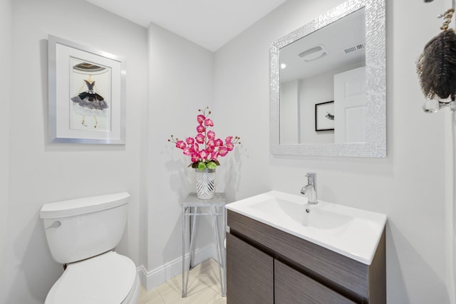 bathroom featuring tile patterned flooring, vanity, and toilet