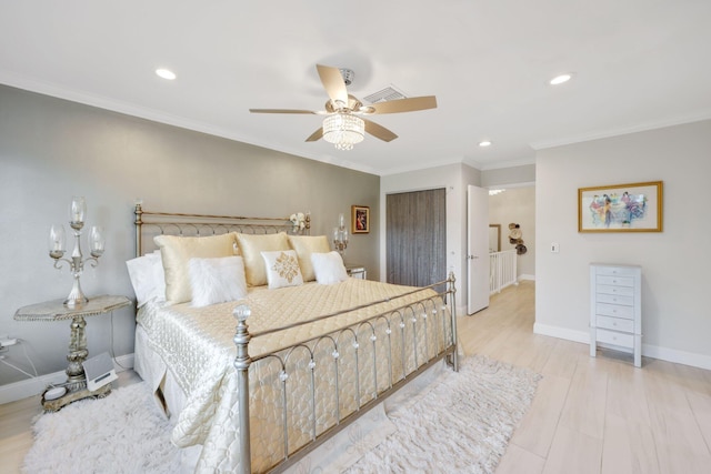 bedroom featuring ceiling fan, ornamental molding, and light hardwood / wood-style flooring