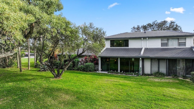 rear view of house with a yard