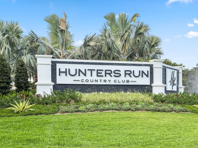 community / neighborhood sign with a lawn