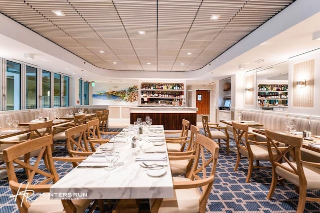 dining room featuring expansive windows and bar