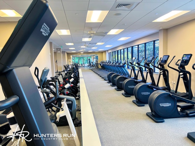 gym featuring a paneled ceiling and ceiling fan