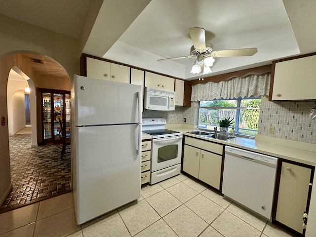 kitchen with tasteful backsplash, white appliances, ceiling fan, sink, and light tile patterned floors