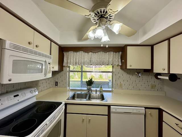 kitchen featuring white appliances, backsplash, white cabinets, sink, and ceiling fan