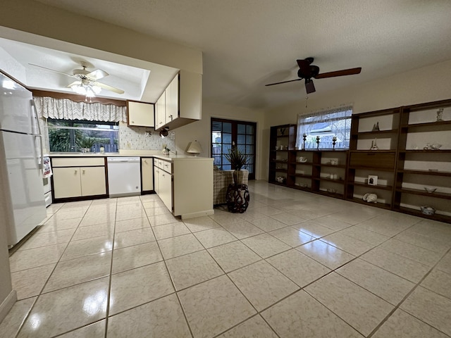 kitchen with white appliances, white cabinets, ceiling fan, a textured ceiling, and tasteful backsplash