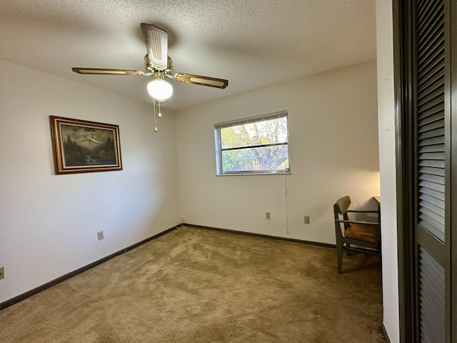 carpeted spare room with a textured ceiling