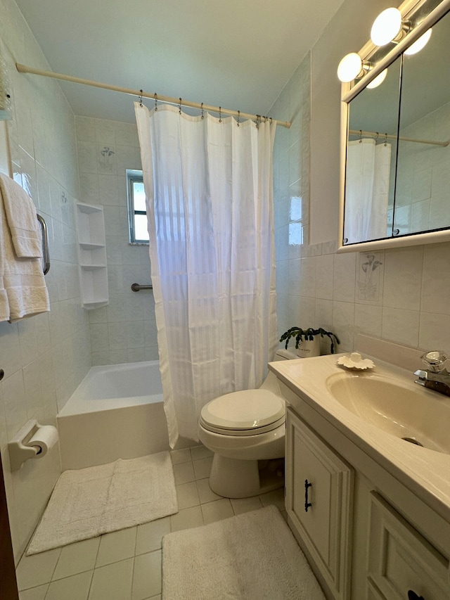 full bathroom featuring shower / bath combo, vanity, tile patterned floors, toilet, and tile walls