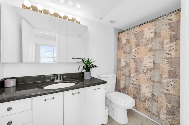 bathroom with tile patterned floors, vanity, and toilet