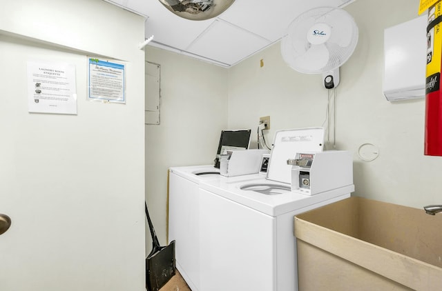 laundry area with separate washer and dryer and sink