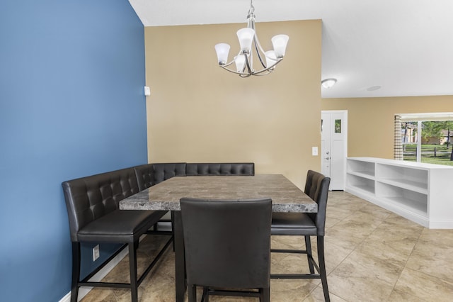 dining space with a chandelier and built in shelves