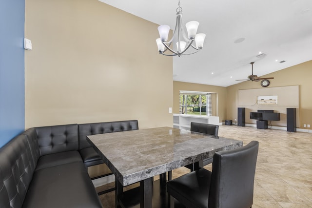 dining room with ceiling fan with notable chandelier and vaulted ceiling