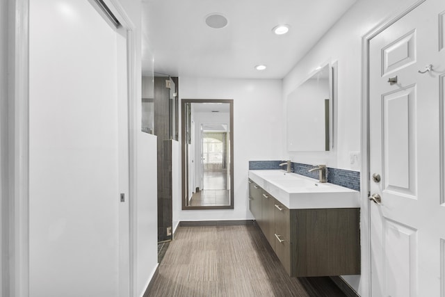 bathroom with hardwood / wood-style floors and vanity