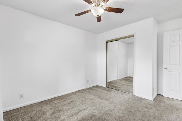 unfurnished bedroom with ceiling fan, light carpet, and a closet