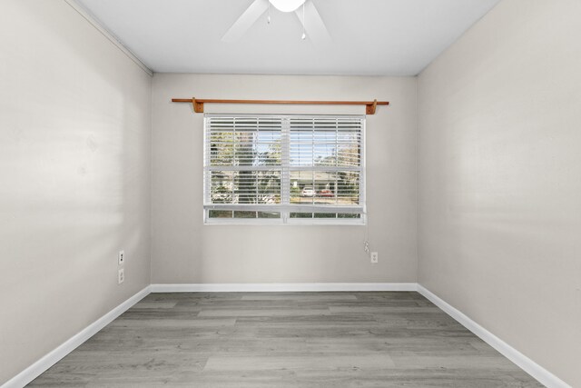 spare room with ceiling fan and hardwood / wood-style flooring