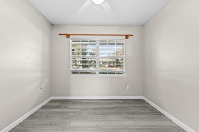 3331 NW 27th Ave, Gainesville, FL 32605 - spare room featuring ceiling fan, wood finished floors, and baseboards