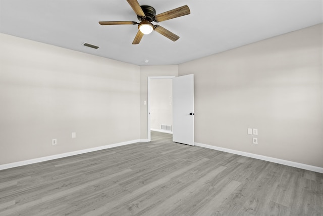 empty room featuring ceiling fan and light hardwood / wood-style flooring