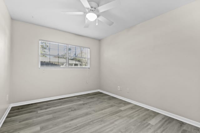 unfurnished room with hardwood / wood-style flooring and ceiling fan