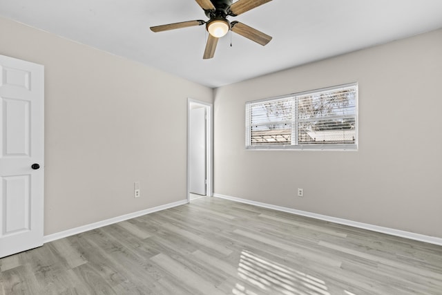 empty room with ceiling fan and light wood-type flooring