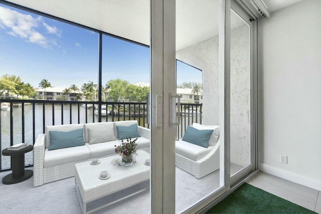 sunroom / solarium with a water view