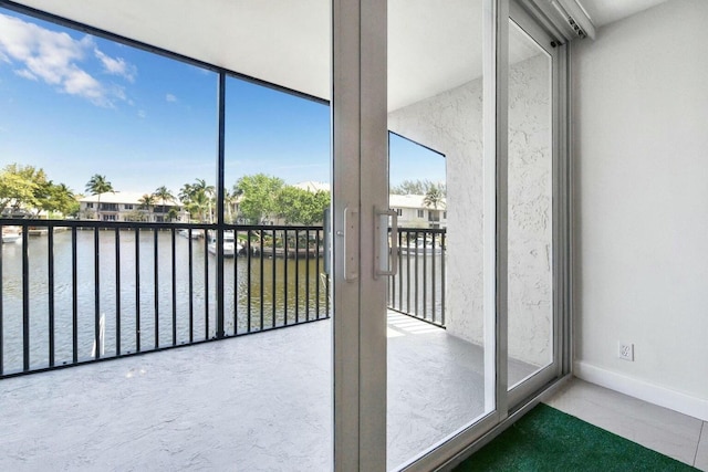 unfurnished sunroom featuring plenty of natural light and a water view