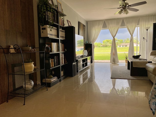 tiled living room with ceiling fan